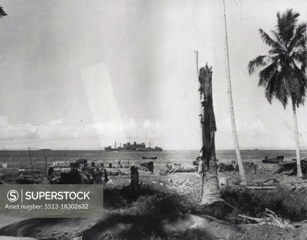 More Help For Guadalcanal -- Standing offshore a U.S. transport unloads men and materials to reinforce yanks on Guadalcanal Island in the Solomons. The tree stumps are mute Testimony of the fierce fighting which has raged on he Island. December 19, 1942. (Photo by AP Wirephoto).