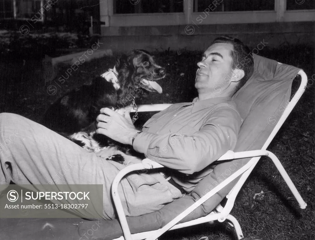 Candidate's Pet -- Vice Presidential candidate Sen. Richard Nixon of California relaxes at home in Washington with the family pet, a cocker spaniel named "Checkers." Nixon, taking a short rest from campaigning, mentioned the dog on his nation-wide broadcast. September 29, 1952. (Photo by United Press International Photo).