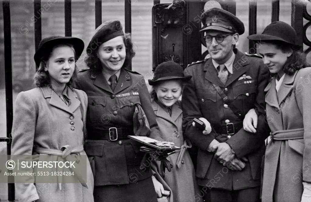 French "Underground" Heroine Decorated At Buckingham Palace -- Mrs. Odette Sansom with her three daughters and Captain Peter Churchill, outside Buckingham Palace after the Investiture. Mrs. Odette Sansom, awarded the George Cross for her work in the French Resistance Movement, visited Buckingham Palace with her three daughters, to receive the decoration from H.M. The King. With her also went Captain Peter Churchill, formerly her Commanding Officer in the Movement, who received the Distinguished Service Order. November 19, 1946. (Photo by Sport & General Press Agency Limited).