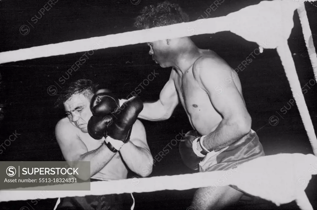 Dave Sands Wins In London -- Sands (right) lands a hard right to Villemain's head.Dave Sands, the Australian triple champion, defeated Robert Villemain, on points in their middleweight contest at Olympia, London, over ten rounds. July 05, 1949. (Photo by Sport & General Press Agency, Limited).