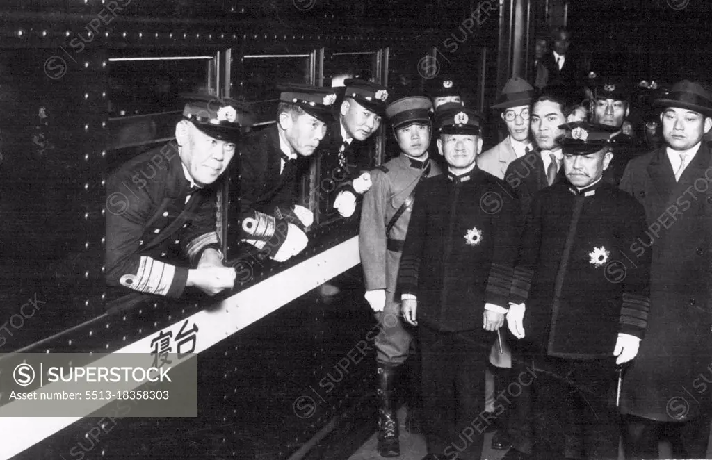 Japanese Naval Delegate to the Geneva Disarmament Conference, Vice-Admiral Shushi Nagano taken at the Tokyo Central Station when he depurated for Geneve. Picture Shows from left in train Vice-Admiral Nagano, Rear-Admiral Hasegawa, a delegate, and out of the train, standing in black uniform, form left, Admiral Keisuke Okada, Naval Minister, Admiral Kanji Okada, one of the biggest leaders of the Navy. December 5, 1932.