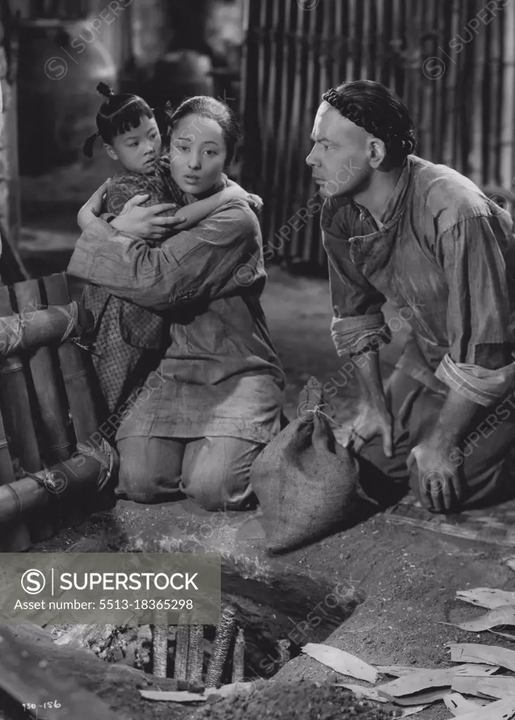 Movie - "The Good Earth".Paul Muni, Luise Rainer and "little Daughter" in the poignant 156 famine episode in Metro-Goldwyn-Mayer's "The Good Earth", directed by Sidney Franklin and produced by Irving G. Thalberg. August 03, 1936. (Photo by Minneapolis Star Library).