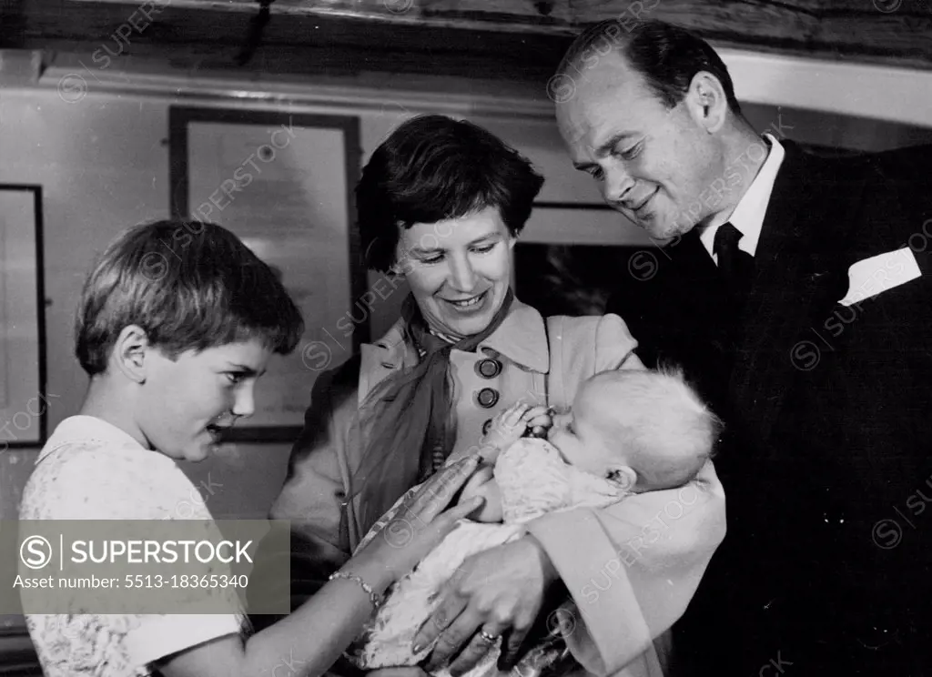 Capt. Scott's Grand-Daughter Christened in ***** - Mrs. Peter Scott, the mother, holds Dafila Kathleen, while Mr. Peter Scott and his daughter by his first marriage, Nicola, look on. They are pictured in the discovery's museum, surrounded by relics of captain Scott.The Grand-daughter of captain Robert Falcom Scott, the famous British Antarctic explorer, ***** Christened today aboard her grandfather's ship, the discovery, moored in the Thames. The ship was used in the British National Antarctic expedition of 1901-4. September 17, 1952. (Photo by Paul Popper).