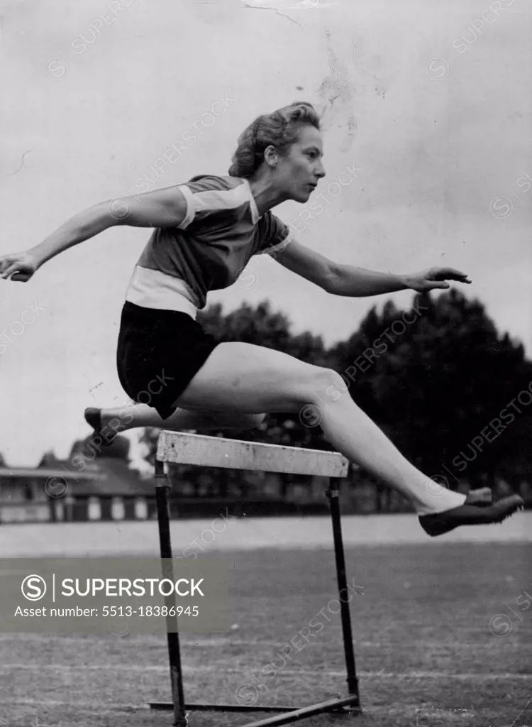 Australian Girl Hurdles To Helsinki Via London -- Miss Shirley Strickland (Western Australia), one of Australia's women athletes for the Olympic Games, practising over the hurdles at Paddington Track, London, today (Thursday).The Australian athletes are in London on their way to Helsinki. Miss Strickland is a 100 and 200-metres sprinter as well as a hurdler. June 19, 1952. (Photo by Reuterphoto).