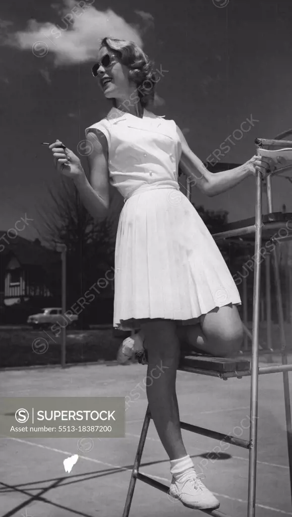 The double-breasted sleeveless dress in white pique has a skirt that's a flurry of knife pleats. December 05, 1955. (Photo by Jack Hickson, Australian Photographic Agency).