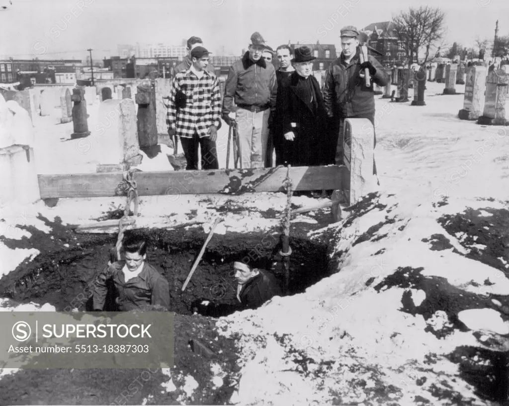 Seminarians Dig Graves -- With Francis Cardinal Spellman as overseer, candidates for the priesthood from St. Joseph's Seminary, Dunwoodie, N.Y., look on today as two fellow students, John Donohue (left) and Kevin Flynn dig grave in strike-bound Calvary cemetery, Queens. Cardinal Spellman asked the seminarians to dig the graves after more than 600 bodies remained unburied. Union gravediggers continued to picket the burial ground as the volunteers entered the cemetery and went to work. March 03, 1949. (Photo by AP Wirephoto).