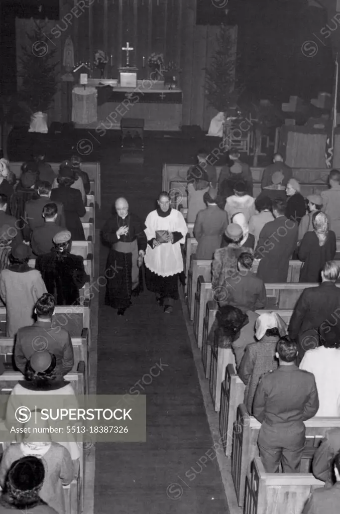 His Eminence Francis Cardinal Spellman (left) and Chaplain (Capt.) Thomas F. Quinn (Cambridge, Mass) Chaplain at Tokyo Chapel center, leave Chapel following celebration of Mass held at the Chapel, Tokyo, Japan. December 23, 1952. (Photo by Milford J. Vickman, U.S. Army).