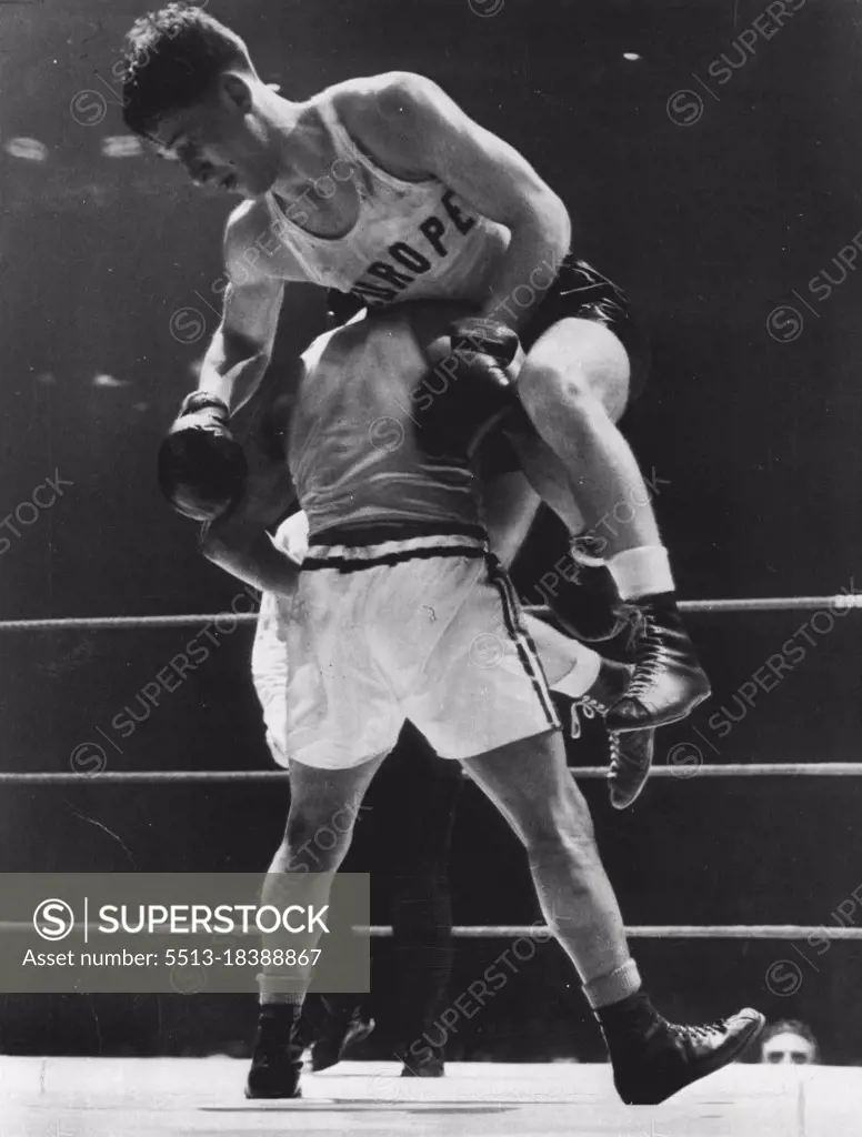 High Spot In International Bouts -- Stig Sjolin of Varanamo, Sweden. is hoisted to the shoulder of Richard Guerrero of Chicago, as the action became fast and furious tonight in l60»pound International Golden Gloves bout at Stadium tonight, Guerrero was awarded a decision. March 30, 1951. (Photo by AP Wirephoto).