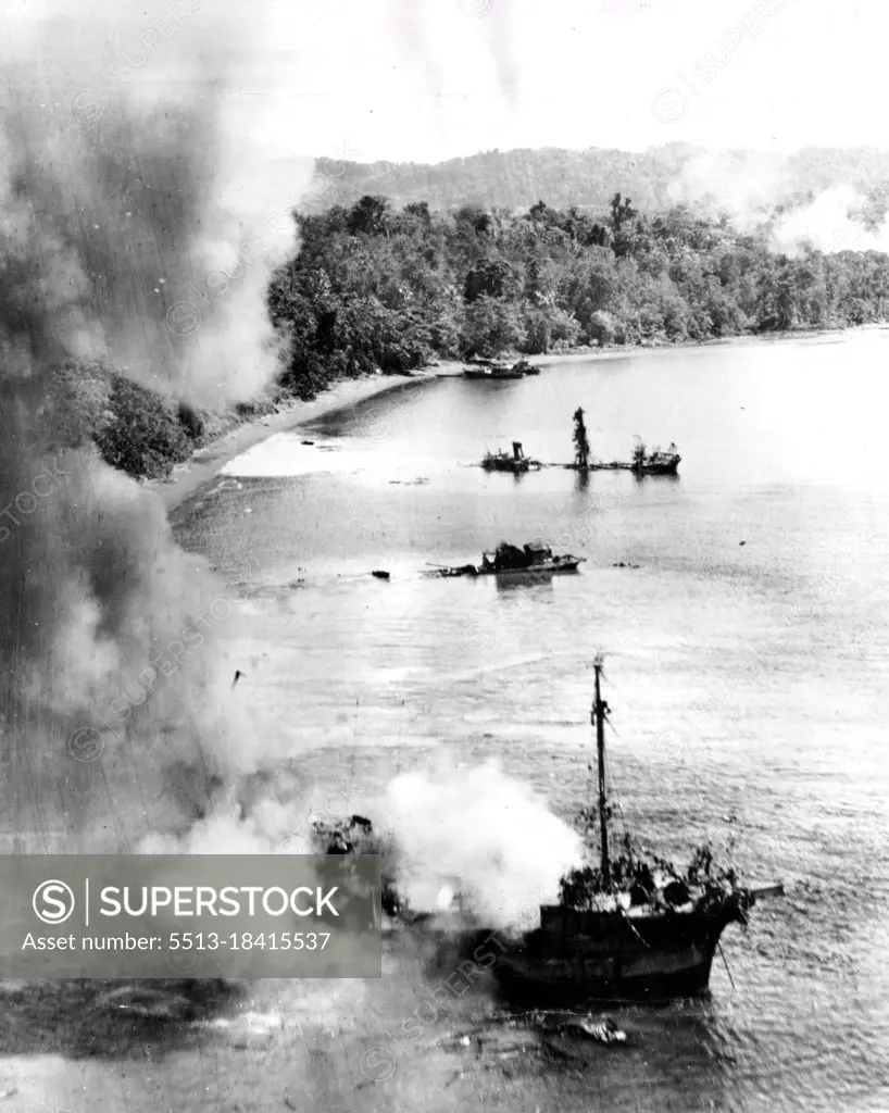 Jap Ship Blasted ... Bombers from the Fifth U.S. Army Air Force attack Japanese Jap Ship Blasted  shipping to and shore installations off Manokwari Dutch New Guinea. The ship in the foreground is aflame as a result of the U.S. masthead attack. Two other ***** ships are sinking and additional bombs are seen bursting in the distance. June 19, 1944. (Photo by USA Fifth Air Force).