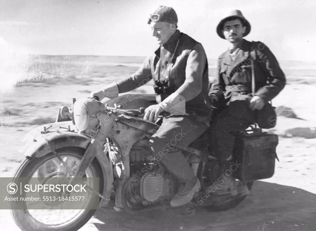 Italian prisoner being taken to headquarters by motor bike. March 01, 1942.