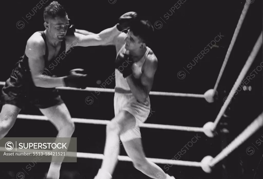 South African Success: G. Hunter (on left) of South Africa photographed during his Olympic fight with Scott of Great Britain whom he defeated in the light heavyweight final. August 13, 1948.