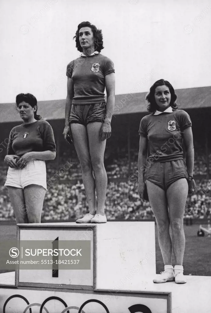 Olympic Games 1948 - Women Discussion - ***** M. Ostermeyer of France ***** gold winner of the Women's ***** even with 137ft 6½ ***** she stands between G.E.C. - ***** Italy who was second (left) ***** of France, third. July 31, 1948.