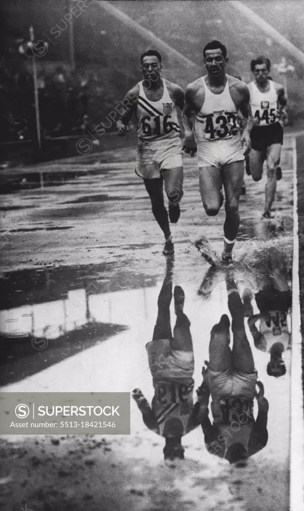 Olympic Games - Decathlon Reflections: E. Kistenmacher (Argentine) No. 432 leading, L. Mondschein (USA) No. 616, and Adamczyk (Poland) No. 445, round the flooded track to win his heat in the Decathlon 1500 metres at Wembley to-day (Friday).Flooded track which hampered running of Olympic events is well shown in this picture of Kistenmacher (Argentina) splashing to victory in the 1500-metre decathlon heat from Mondschein (USA) and Adamczyk (Poland). August 05, 1948. (Photo by Reuterphoto).