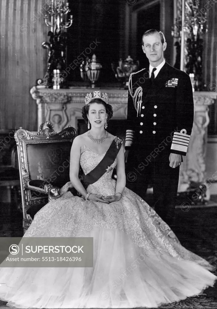 H. M. Queen Elizabeth II And H.R.H. The Duke of Edinburgh - A new portrait of Her Majesty Queen Elizabeth II and her husband, His Royal Highness the Duke of Edinburgh taken in the Green Drawing Room of Buckingham Palace. Her Majesty the Queen is wearing a pale pink evening gown of needlework lace over tulle, with the blue Ribbon and Star of the Garter, and with it a Russian fringe design diamond necklace (a wedding present from the City of London), diamond drop earrings and two diamond bangles. The diamond drop brooch at the top of the blue Ribbon is a family heirloom and has been worn by the late Queen Mary. April 26, 1953. (Photo by Camera Press Ltd.).