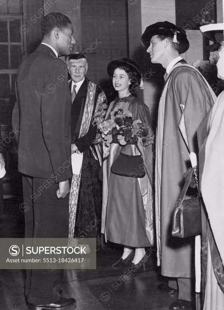 London University Honours Princess And Duke -- Arthur Wint, winner of the 1948 Olympic Games 440-yards event, is presented to Princess Elizabeth and the Duke of Edinburgh after the royal couple had received honorary degree of Doctor of Law at London University. The Presentations were made by the Earl of Athlone, chancellor of the University (in background). December 11, 1951.