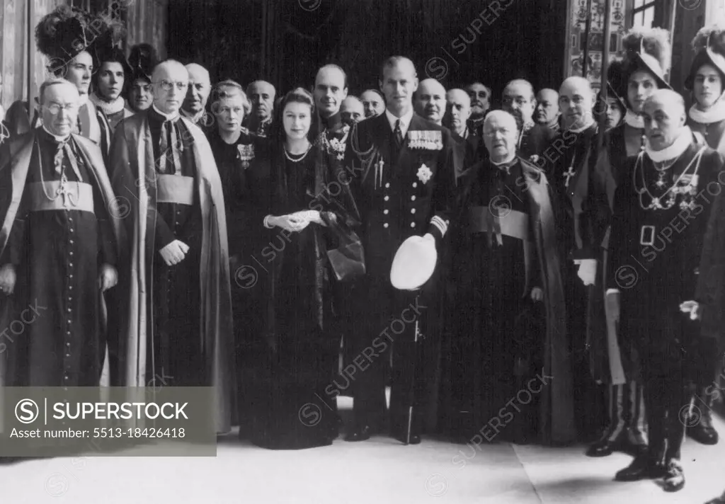 Princess And Duke See The Pope -- Princess Elizabeth (centre) with the Duke of Edinburgh (on her left), seen when they had private audience with the Pope. Wearing a black velour dress, reaching to the ground, and a black veil of Spanish lace, Princess Elizabeth, accompanied by the Duke of Edinburgh, was received in audience by Pope Pius XII. The Duke was in Naval uniform. Welcoming the royal couple in fluent English, the Pope asked after their children and sent his respects to the King and Queen. April 13, 1951.