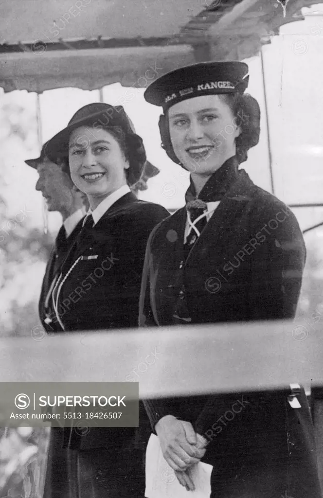 Princesses take Salute at girl Guides Rally. Princess Elizabeth and Princess Margaret attended the Girl Guides Rally which was hold in the Cockpit, Hyde park this afternoon. Princess Elizabeth took the salute at the march past. A happy photograph showing Princess Elizabeth and Princess Margaret on the Royal dais in Hyde Park this afternoon. May 10, 1946. (Photo by Sport & General Press Agency Limited).