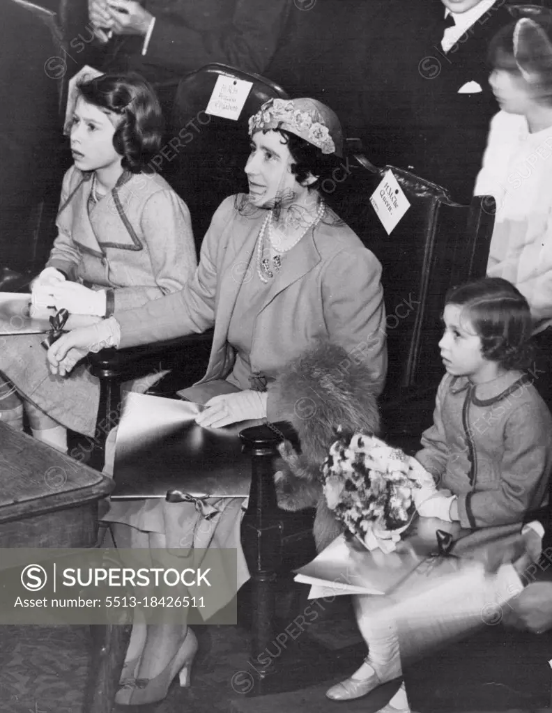 The Queen Attends Children's concert. Celebrating the coronation, a series of concerts for children are being held at London, York and Coventry. H.M. The Queen, accompanied by the Princess Elizabeth and Princess Margaret Rose, attended the Robert Mayer's Invitation coronation concert, conducted by Dr. Malcolm Sarjent, at the central hall, Westminster, London. Studies in concentration. H.M. The Queen with the little Princess keenly interested in the performance. April 6, 1937. (Photo by Sports & General Press Agency Limited)