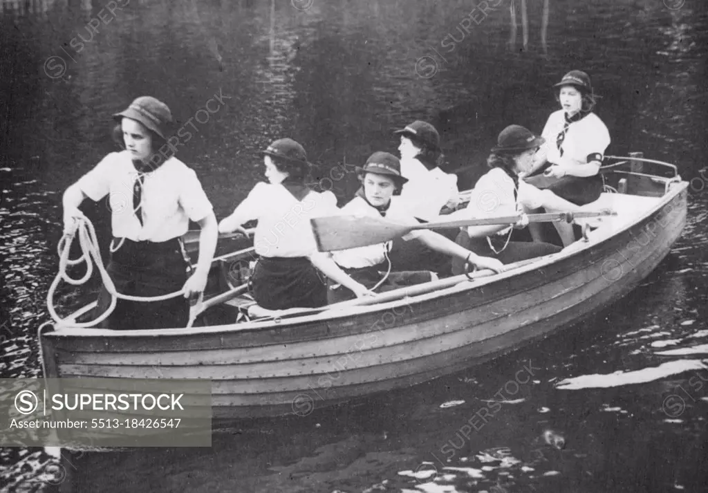 Princess With Girl Guides : Sea Ranger Princess Elizabeth takes the tiller during boating exercise. Princess Elizabeth and her sister Princess Margaret Rose visited a Girl Guides Camp. July 25, 1944.