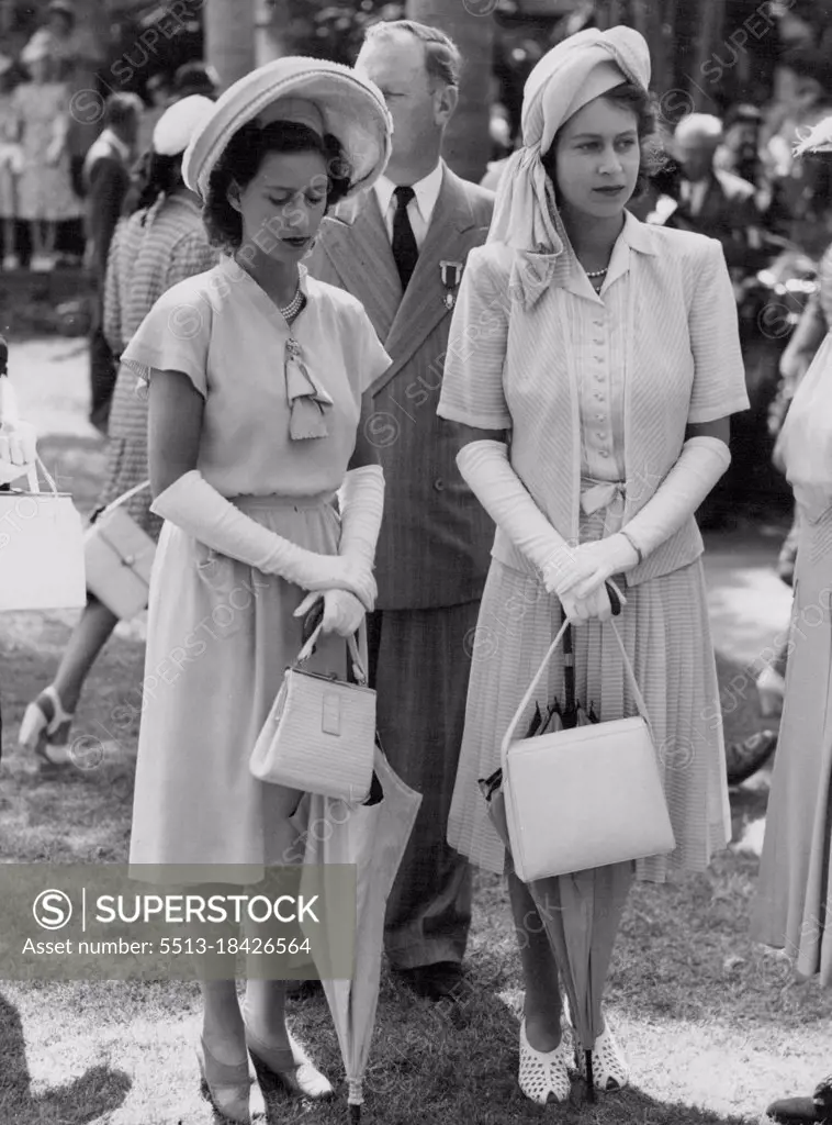 The Royal Family At Durban: Visit to Greyville Races. Princess Margaret Rose (left) and Princess Elizabeth (right) strikingly dressed, and complete with sunshades and handbags, photographed during the meeting. During their visit to Durban, Natal, while on their tour of South Africa, the Royal Family went to the Durban Turf Club meeting at Greyville Racecourse, to witness the King's Cup Race. March 26, 1947.