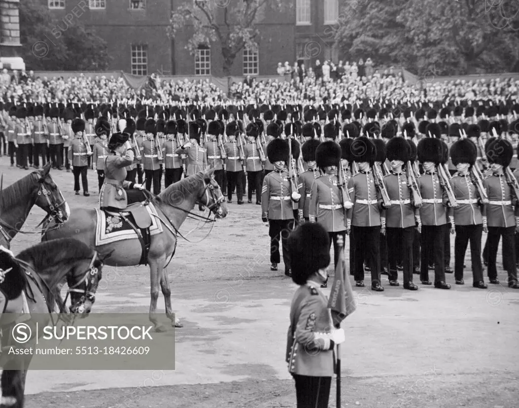 Queen taking the salute at the Trooping the Colour ceremony on horse Guards parade. The Queen rode from Buchingham palace today to take the salute at the trooping the Colour ceremony on Horse Guards parade. Record crowds lined the route to watch the Queen go by, and from the early hours of this morning people had waited on Horse Guard's parade to see the ceremony. The Queen rode side-saddle on the police horse Winston and wore her specially designed Guard's uniform - a scarlet tunic, dark blue riding skirt, and a tricorne hat with the gold badge and white plume of the Grenadiers. Behind the Queen rode Prince Philip, in fieldmarshal's uniform, and the Duke of Gloucester, Colonel of the Scots Guards. On horse guards parade, the Colour of the 1st Battalion the Grenadier Guards, the senior Guards regiment, was trooped. After the ceremony the Queen rode back along the Mall where she took a final salute at the gates of Buckingham palace. June 11, 1953. (Photo by Daily Mirror).