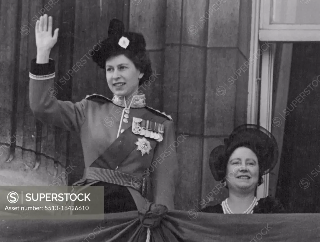 Queens At Palace After Trooping - The Queen waves from the balcony of Buckingham palace to watching crowds below, as with the Queen Mother she appeared on the balcony prior to the Royal Air force fly past which followed the Trooping the Colour ceremony. The Trooping and fly past marks the Queen's official birthday. June 5, 1952.