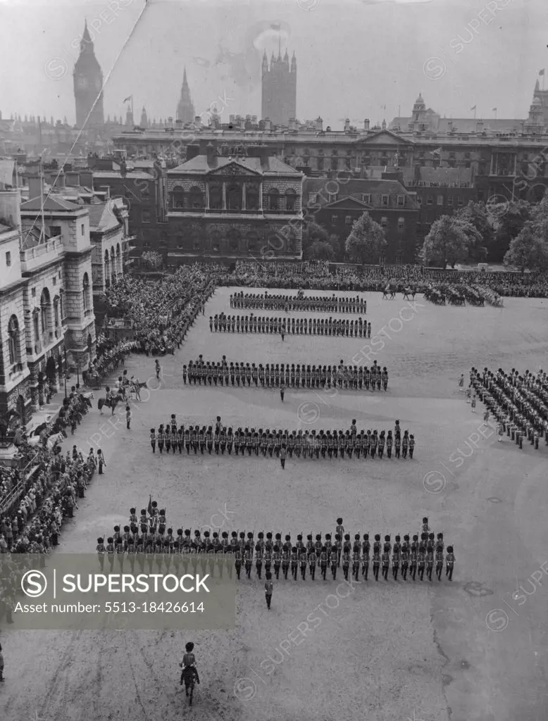 The Guards March Past- Retaining their famed straight ranks the Guards march past the Queen, who is at left with the Duke of Edinburgh and the Duke of Gloucester. The Queen's official birthday was celebrated today (Thursday) with the traditional ceremony of Trooping the colour, this year that of the Coldstream guards, on one guards parade. By coincidence today is the actual birthday of the Duke of Edinburgh, who is 38. Her majesty was 28 on April 21. June 10, 1954. (Photo by Reuterphoto).