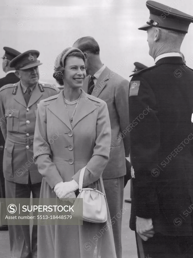 Chat With a driver: Radiant as she inspects the Royal Visit Car Company, the Queen pauses to chat with one of the drivers before boarding the aircraft. Behind her the Duke talks with Royal Visit Director-General F.H. Berryman. April 24, 1954.