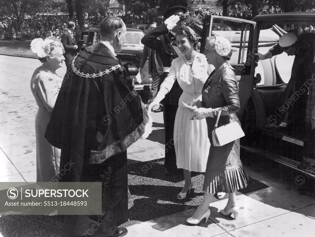 Royal Tour Melbourne Victoria. With a bright smile, the Queen steps from her car to shake the hand of the Mayor of St. Kida, Cr. W.E. Dickeson, as she arrived at the St. Kilda Town Hall for the combined women's organisations luncheon. On the right is Mrs. John Cain, wife of the Premier. March 05, 1954.