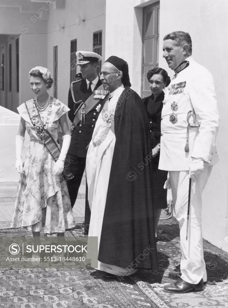 "The Queen Is Home" -- With King Idris of Libya, at his palace in Tobruk, Her Majesty the Queen and the Duke of Edinburgh appear on the balcony overlooking the harbour. Lying there at her mornings was the Royal yacht "Britannia" with Prince Charles and Princess Anne on board waiting for the happy reunion wish their parents after the long months of separation. June 1, 1954.