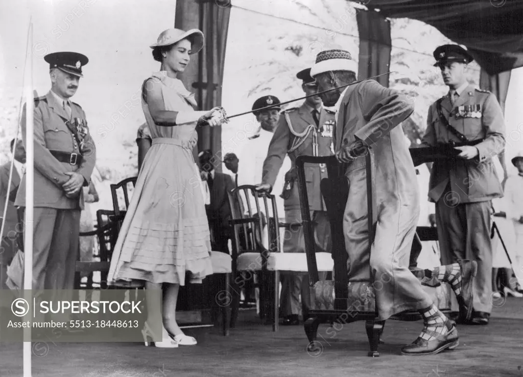 The Queen Knights A Sheikh -- The Queen gives the traditional tap on the shoulder with a sword to Senid Bubaker Bin Sheikh Al Kaf, Councillor of the Kathiri State, when she knighted him during the ceremonies at Aden yesterday. April 28, 1954.