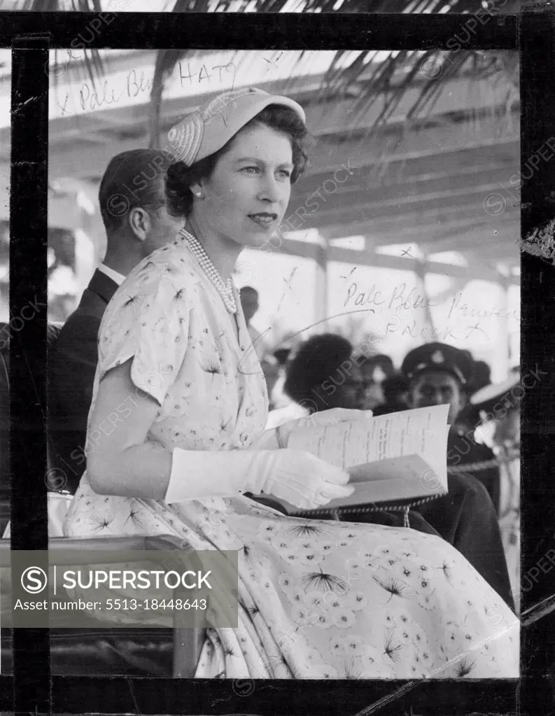 At Churchill Park, Lautoka, the Queen watches a sports meeting. Soon after, crowds mobbed her car. December 30, 1953.