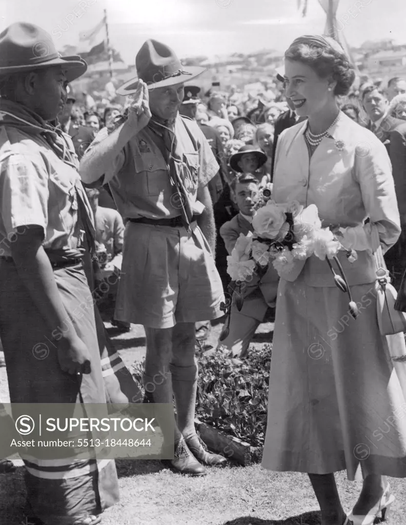 Queen Elizabeth greeting Samoan Scouts who were in the South Island for a jamboree. This picture was taken at Timaru, NZ.Colourful Dress - Scouts from Samoa, who were attending a jamboree near Timaru, will recall for many years the day they met the Queen. The scoutmaster salutes as Her Majesty talked to one of the scouts, whose colorful dress impresses the Queen. February 03, 1954.