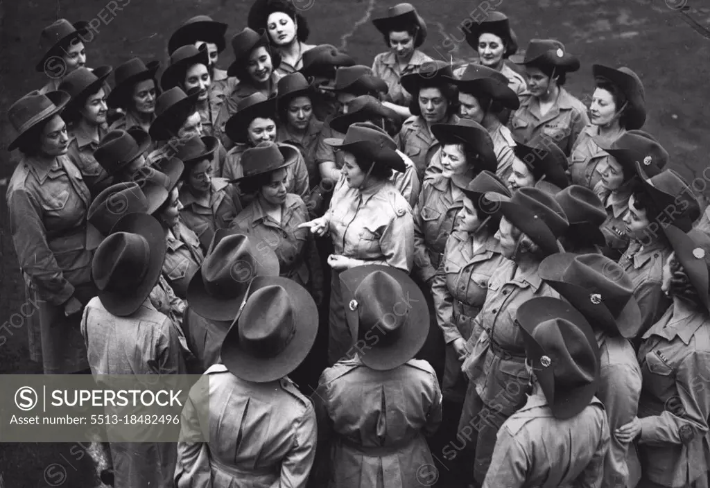 "Canteen Commandos" For Singapore - Senior-Commander Shepherd, of Bath, giving the girls a few hints at a parade in London, when they were fitted out with their tropical kit. A large party of N.A..A.F.I. girls will shortly be at work in Singapore, for the first time in Naffi history in the Far East. They are members of the E.F.I. (Expenditionary Forces Institutes), who earned the nickname of "Canteen Commandos" on the various war fronts. February 12, 1946.