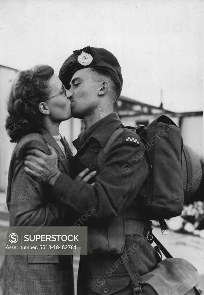 A Kiss Before Korean Flight - A last embrace and kiss between Private Godfrey Gethen and his wife, Maisie, of Nottingham, before the soldier boarded an airport here to fly to Korea in company with two officers and 63 men of the Argyll and Sutherland Highlanders. Blonde, and 22, Mrs. Gethen had travelled down from her home to see her husband off. Until a few months ago most of the men were serving with the Boar in Germany. Nearly all of them had volunteered for service in Korea. September 15, 1950. (Photo by Planet News Ltd.). 