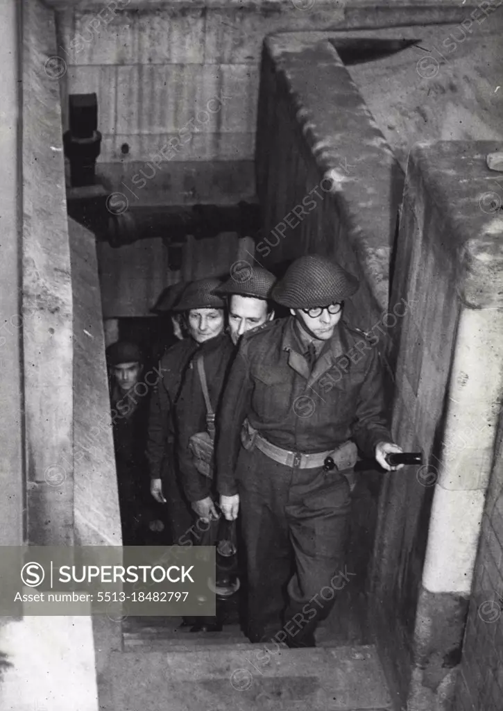 Vaults Searched By Home Guards -The search in progress. For the first time in history. Parliament provided its own armed guard for the traditional ceremony of searching the vaults before the opening of the session. A detachment of the Palace of Westminster Company of the Home Guard made the search in place of the beefeaters. January 13, 1944. (Photo by London News Agency Photos Ltd.). 