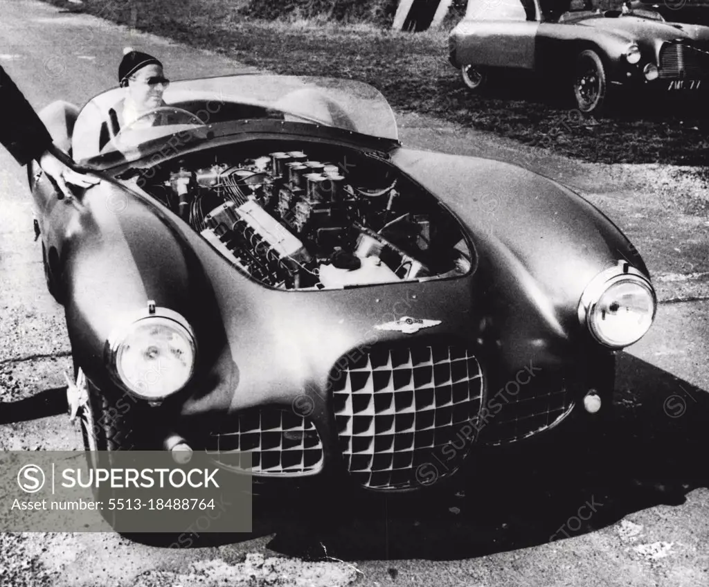 'Test-Bed on Wheels' is to Race - The massive engine which lies under the bonnet is shown in this picture of the David Brown Lagonda - an entirely new competition car - taken at a secret test circuit when it made its first run.At the wheel is Mr. David Brown, who carried out the first series of test runs.The car, which has a 4½ litre V12 engine, is described as an experimental test-bed on wheels'. It is being entered for international events because racing provides the most arduous test.The David Brown Lagonda will make its first appearance at the Silverstone circuit on May 15. Reginald Parnell will drive one in the International Sports Car Race. April 21, 1954. (Photo by Reuterphoto).