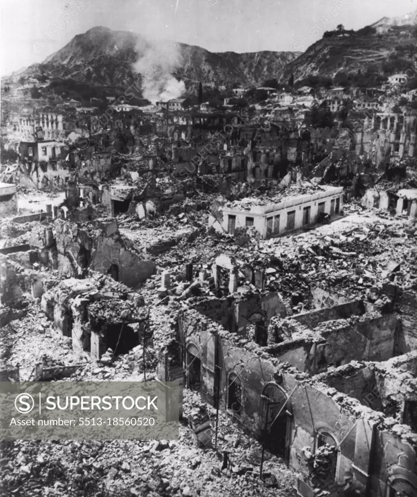 Graveyard Of A Greek City -- Not a living thing is visible amid the rubbled buildings of Zakinthos,one of the Greek island communities destroyed in last week's series of earthquakes. Smoke still rises from a-burning building in this low-level air view by Associated Press staff photographer Eddie Worth. Naval ships of five nations were pouring in tons of emergency supplies for hungry and homeless survivors today as new tremors shook the devastated islands of Kefallinia, Ithaca and Zakinthos. August 17, 1953. (Photo by Eddie Worth, AP Wirephoto).