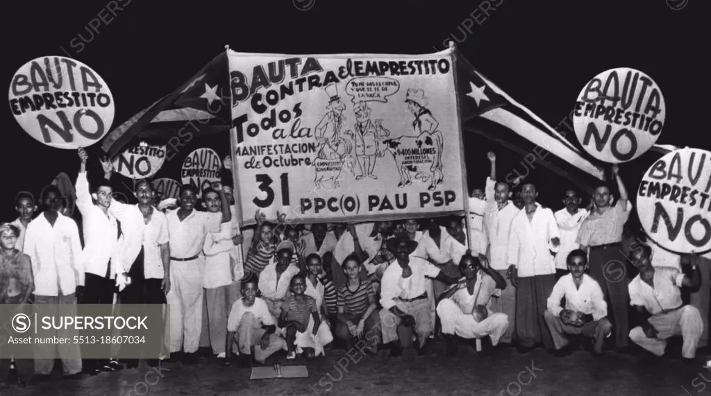 Demonstrate Against World Bank Loan To Cuba -- A delegation of Cubans from Bauta, near Havana, display signs they carried in the Oct. 31 demonstration in Havana against a proposed World Bank loan to Cuba. Sign depicts Uncle Sam leading a goat labeled "$200,000,000 Loan" while a typical Cuban leads a cow labeled to represent the $400,000,000 the protesters say Cuba will pay in amortization of such a loan. The center figure is Cuban President Carlos Prio Socarras telling Uncle Sam "You give me the goat and I'll give you the cow" -- which the demonstrators regard as a poor exchange. November 02, 1949. (Photo by AP Wirephoto).