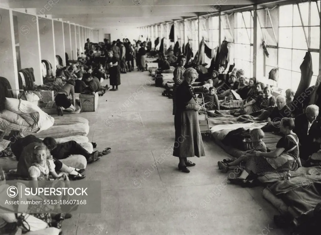 Refugees Pouring Into Prague From Sudentendland.3,000 Housed in Football Stadium.Refugee families resting on matresses at the Masaryk Stadium near Prague.3,000 of the refugees from Sudenten German areas who are pouring into Prague, are being housed and fed in the Masaryk football stadium. They are sleeping on matrsses in the corridors and dressing rooms of the Arena. The many small children among the refugees are being oared for by Red Cross nurses and volunteers. September 19, 1938. (Photo by Keystone).