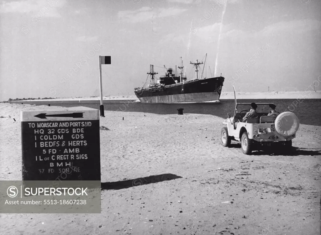 Egyptian Sabres Rattle -- A freighter passed through the Canal watches by British soldiers. The sign-post direct to British army units in the area. January 15, 1954. (Photo by Paul Popper Ltd.).