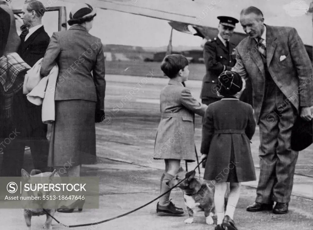 Prince Charles and Princess Anne kept a tight hold on their Corgis, Susan (left) and Sugar, when they prepared to board a plane at Aberdeen. Even so, Susan didn't seem at all impressed and would have preferred to inspect the airport. Sugar was much better behaved. The Royal children. July 16, 1955. (Photo by Daily Mirror).