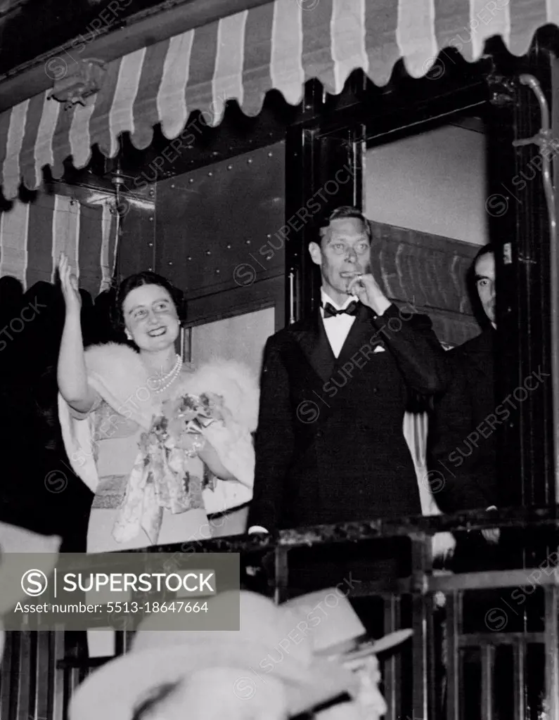 Farewell to the United States -- King George and Queen Elizabeth as they stood on the rear platform of the Royal Train and waved goodbye to President and Mrs. Roosevelt on the night of June 11th as they departed from the United States after their four day visit. June 11, 1939. (Photo by ACME).