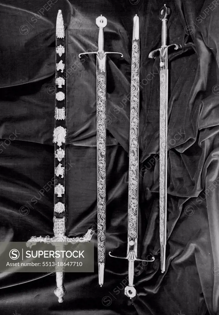 (Top to Bottom) The Sword of stateThe Sword of spiritual justiceThe Sword of Temporal justiceThe Sword of Mercy (Known as Curtana)The Sword of State is in two-handed sword, the length of the blade being 35 inches. The handle is of gilt metal, the cross-pieces representing the lion and the unicorn. The scabbard is decorated with diamonds, rubies and emeralds in designs of the Rose, the thistle and the Shamrock. At the Coronation the Peer who carries the Sword of State delivers it up to the Lord Champion who, in exchange, gives him the Jewelled Sword. December 03, 1952.