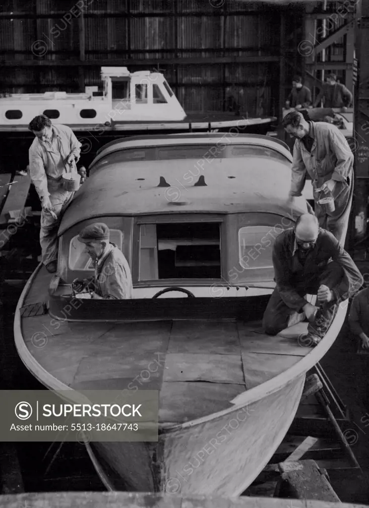 'Britannia's' Royal Barge Being Made Ready for Coronation Review: Craftsmen working on the Royal barge at Portsmouth Dockyard.The Royal barge for the new Royal yacht Britannia (launched by the Queen on Clydeside recently) is now being prepared at Portsmouth Dockyard. The barge, built by a Portsmouth film in 1938, is being stripped, re-painted and re-gilded by a band of skilled craftsmen in the Dockyard's big boathouse. Before the barge 'joins' the Britannia she will be in attendance upon H.M.S. Surprise (the despatch vessel to be used by the Queen and the Duke of Edinburgh) during the Coronation Naval Review. April 28, 1953. (Photo by Reuterphoto).