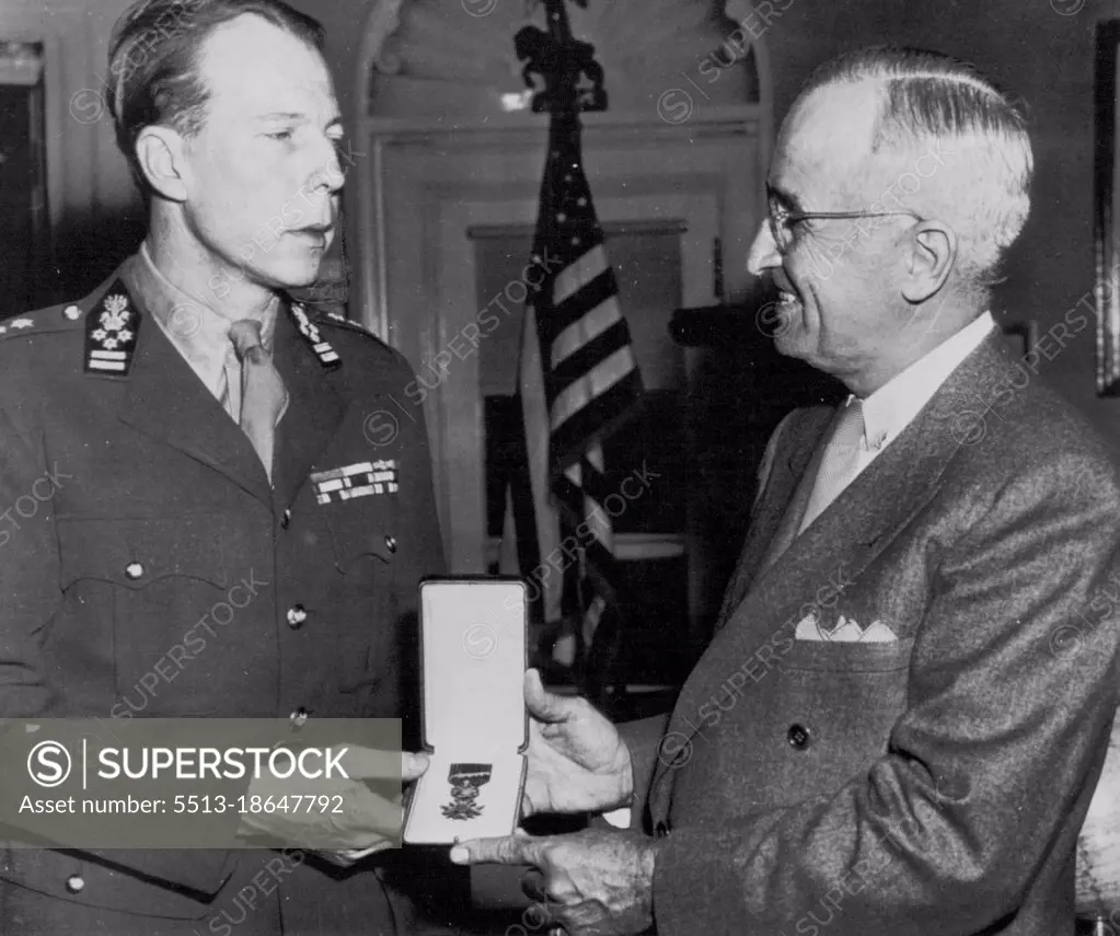 Prince Presents Medal - Prince Charles (left) of Belgium today presents to President Truman a Belgian Croix De Guerre for the U.S. unknown Soldier of World War two. The award was made with the stipulation that the honor be paid to the unknown U.S. service man whose body is brought back from a foreign Battlefield and enshrined in this Country. The presentation was made in the President's office at the White House. April 7, 1948. (Photo by AP Wirephoto).