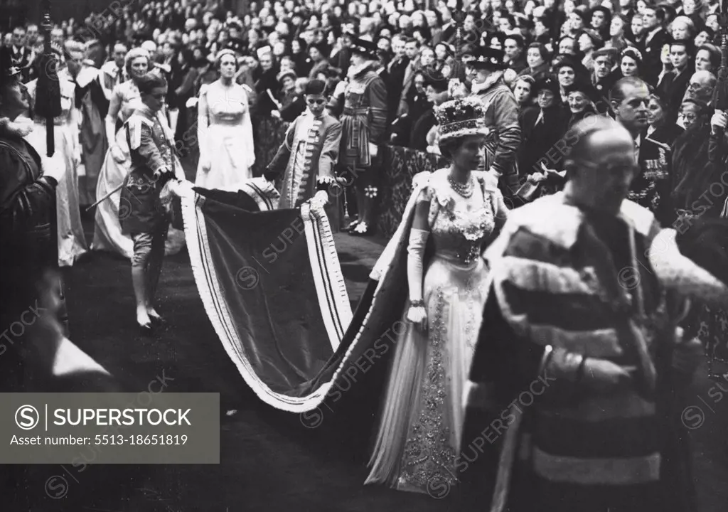 State Opening Of Parliament.The magnificent scene of pageantry as Her Majesty The Queen in her Robes and wearing the Imperial Crown, leaves the Robing Room and walks in procession through the Royal Gallery to the Chamber of the House of Lords to perform the State Opening of Parliament. Her Majesty is accompanied by H.R.H. The Duke of Edinburgh and proceeding them (extreme right) is The Marquess of Salisbury bearing the Cap of Maintenance. Her Majesty's pages are the Hon. Anthony Tryon and Edward Adeane Esq. (This is the first occasion that it has been allowed to talks a photograph of a reigning Monarch wearing the Imperial Crown in the Royal Gallery). November 30, 1954.