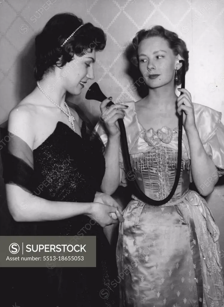 Fashionable Hearing - The old You Know - the New You Cannot See. Hazel Innes, on the right shows an Edwardian type of hearing aid to Gillian Davis, who is in fact wearing a modern hearing aid which is incorporated in the Pearl Necklace she is wearing, the main "Michrophone" part being in the Cluster of Pearls in the front of the Necklace.A Unique Fashion show was held in London today, ***** the latest trends in ***** Hearing Aids.Among those ***** were models ***** ties, Scarved and ***** for men and in ear-rings, ***** scarf clasps, Hair-bands and Necklaces for women. May 10, 1955. (Photo by Paul Popper, Paul Popper Ltd.). 