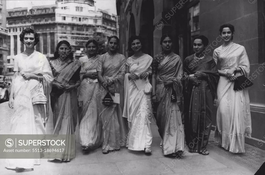 Just The Weather For Their Garden Party At The Palace -- London's sweltering weather, near to that of their own country, was all these debutantes from India needed to make their day just perfect. Leaving India House on their way to a presentation garden party at Buckingham Palace this afternoon are, left to right: the Misses Kothari, Zachariah, Talukdar, Mayor, Mugaseth, Sundaram, Thapar and Gideon. July 14, 1955. (Photo by Reuterphoto).