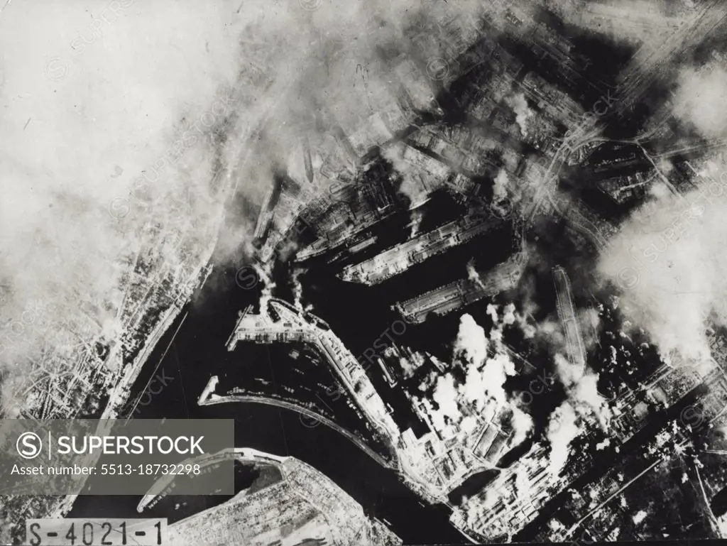 War History - 18 -- Hamburg, when this air photo was taken from an American Flying Fortress, was the most heavily bombed city of its size in the worlds. It had then been mode virtually useless as a military, manufacturing and shipping center. Moving through the smoke pall over the city, American Fortresses followed up a series of blanket bombings by the Allies, and in this raid have nicked out the Howaldstwerke submarine shipyards. August 1, 1945.